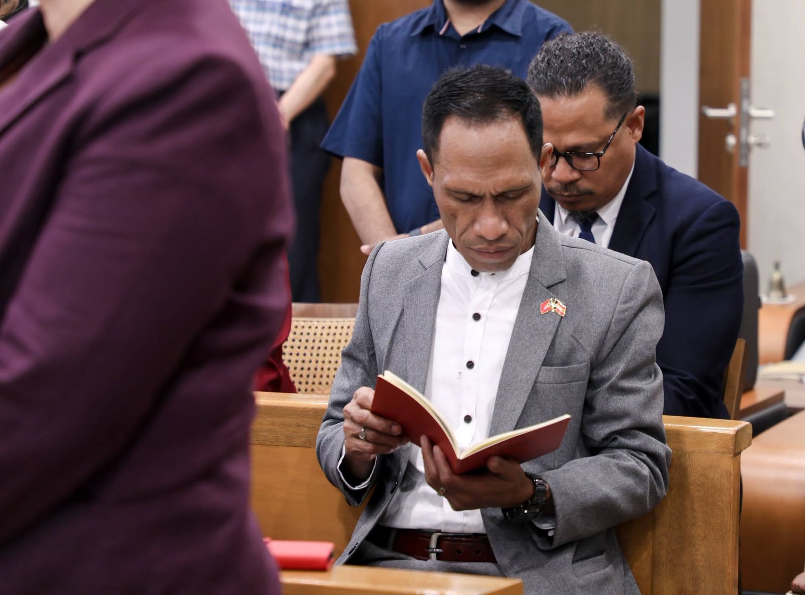 Delegation member reading the missal