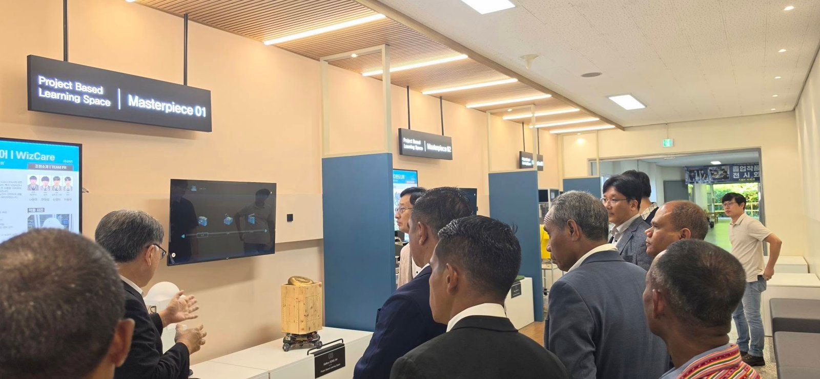 Delegation inspecting Project Based Learning gallery at Dong-Ah Meister High School