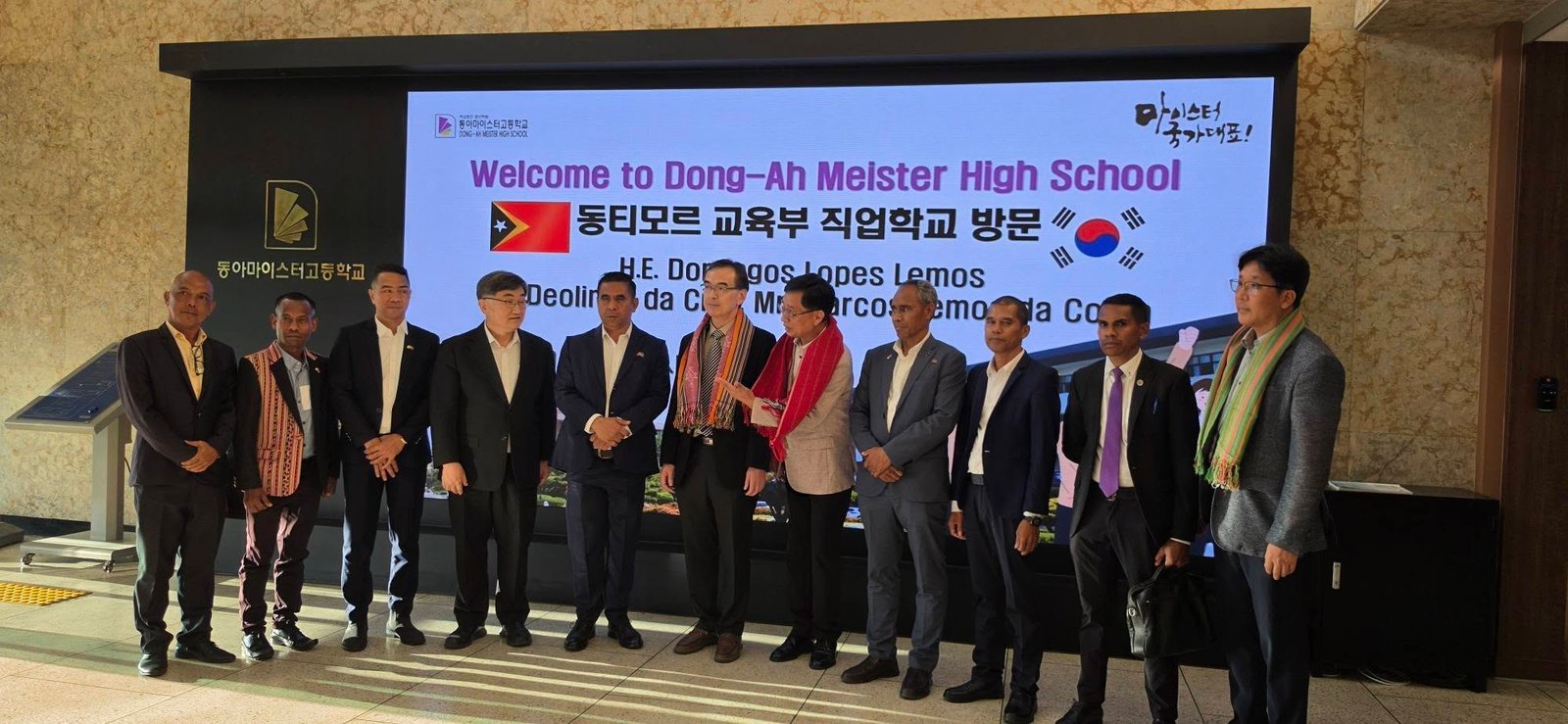 Official group photo at Dong-Ah Meister High School entrance