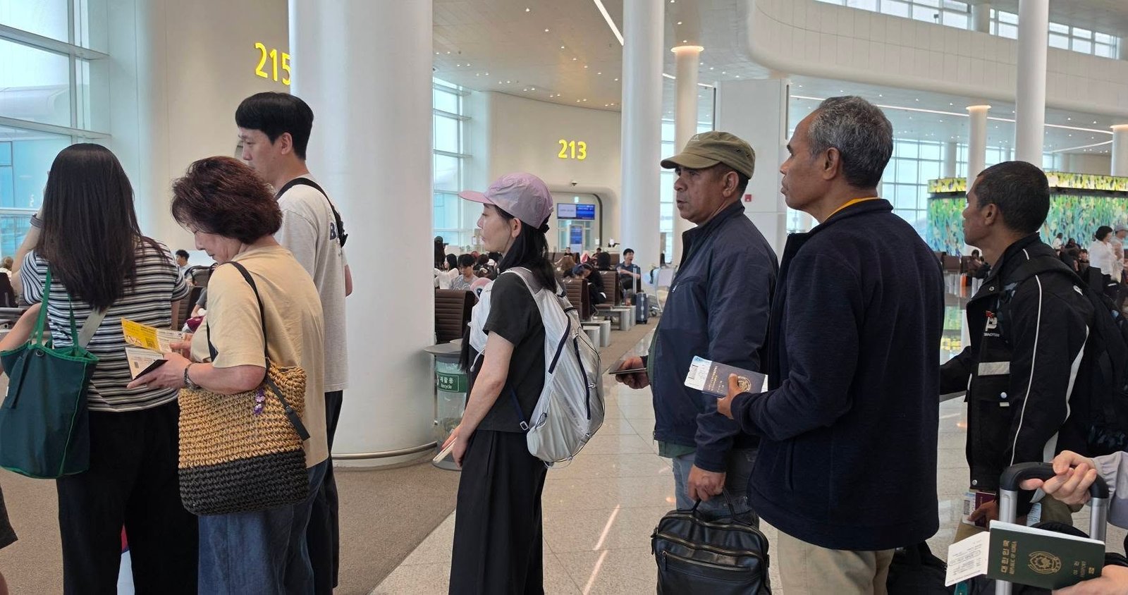 Delegation members waiting at the departure gate concourse