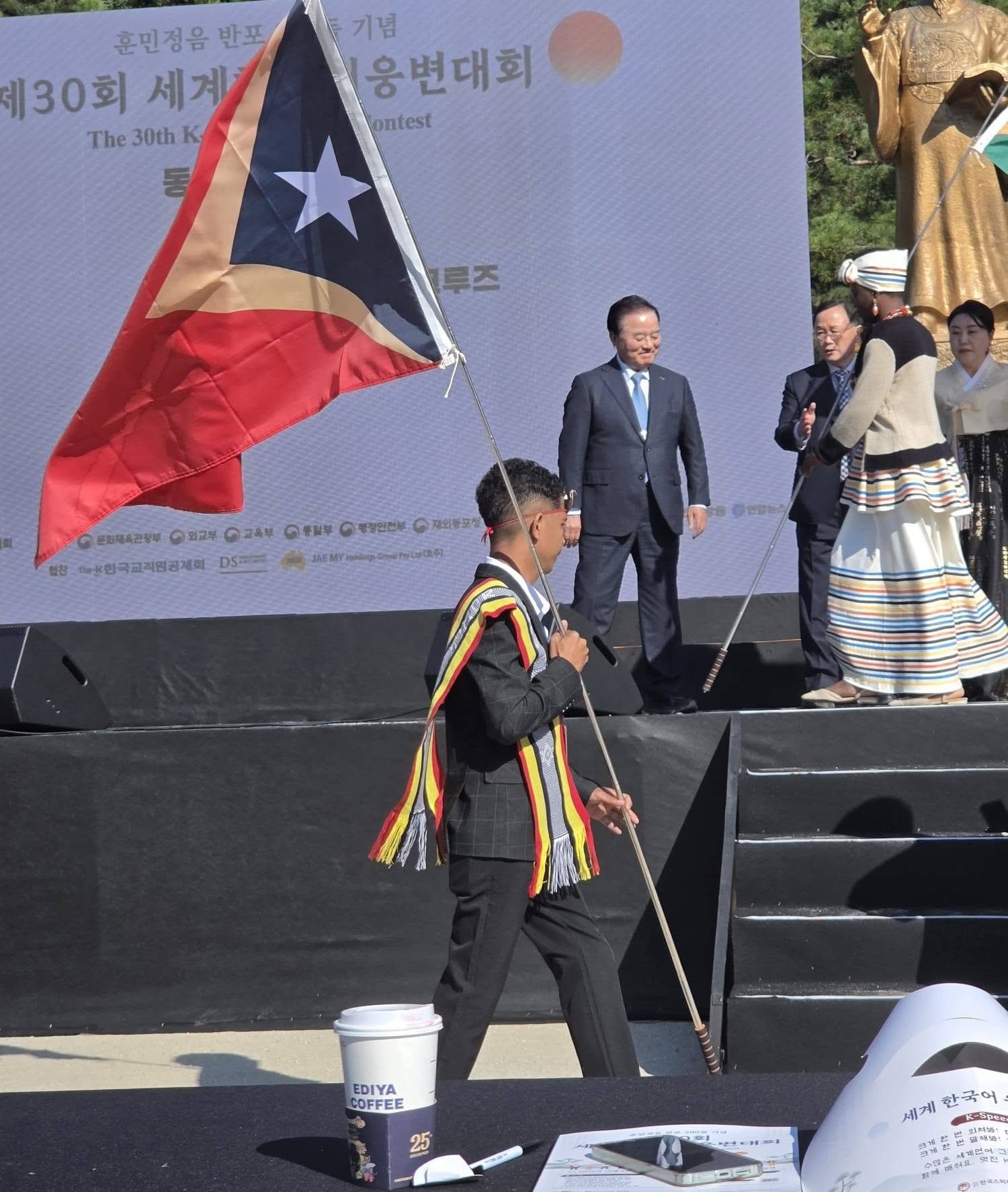 Afonso Ramerio da Cruz carrying the national flag of Timor-Leste